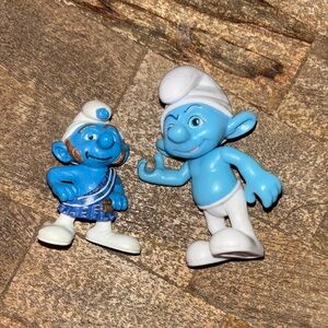 Two smurf figurines